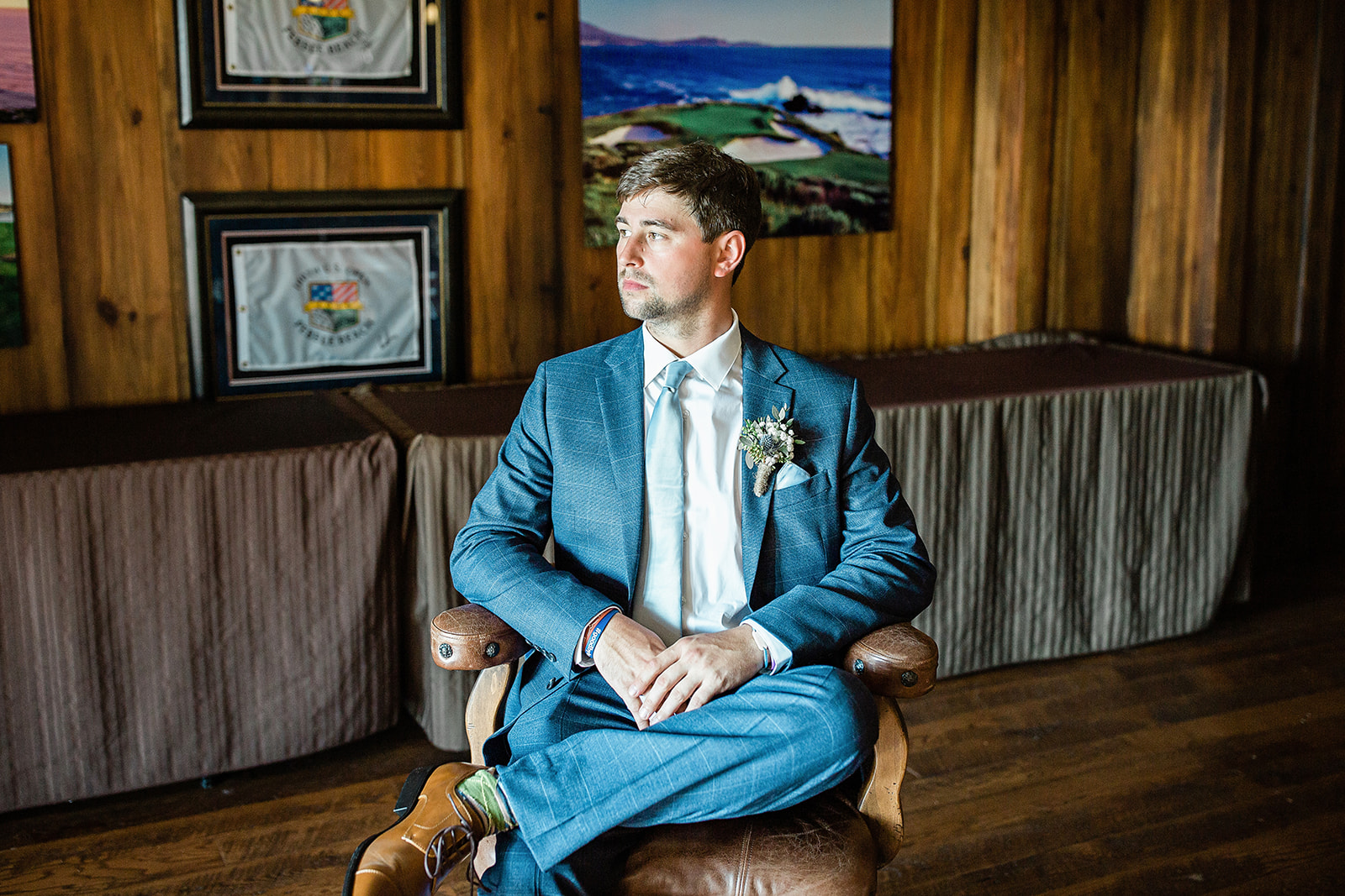Groom taking his portrait inside the getting ready suite
