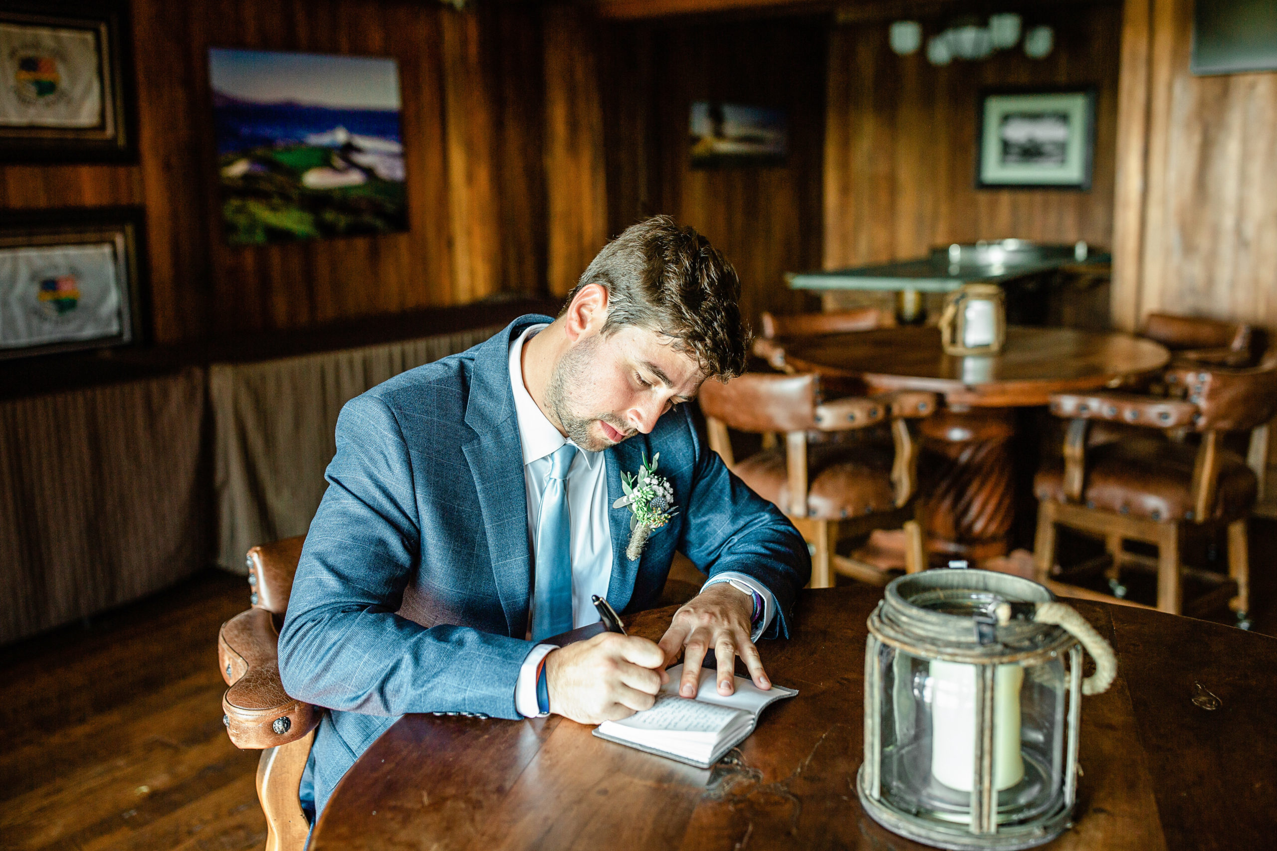 Groom writing his vow to his bride