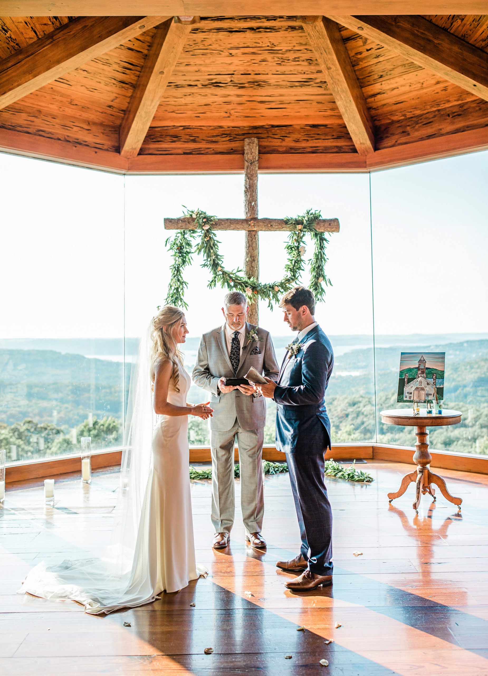 Bride and groom reading their vows during the ceremony at Chapel of the Ozarks, Branson Missouri by Tatyana Zadorin Photography