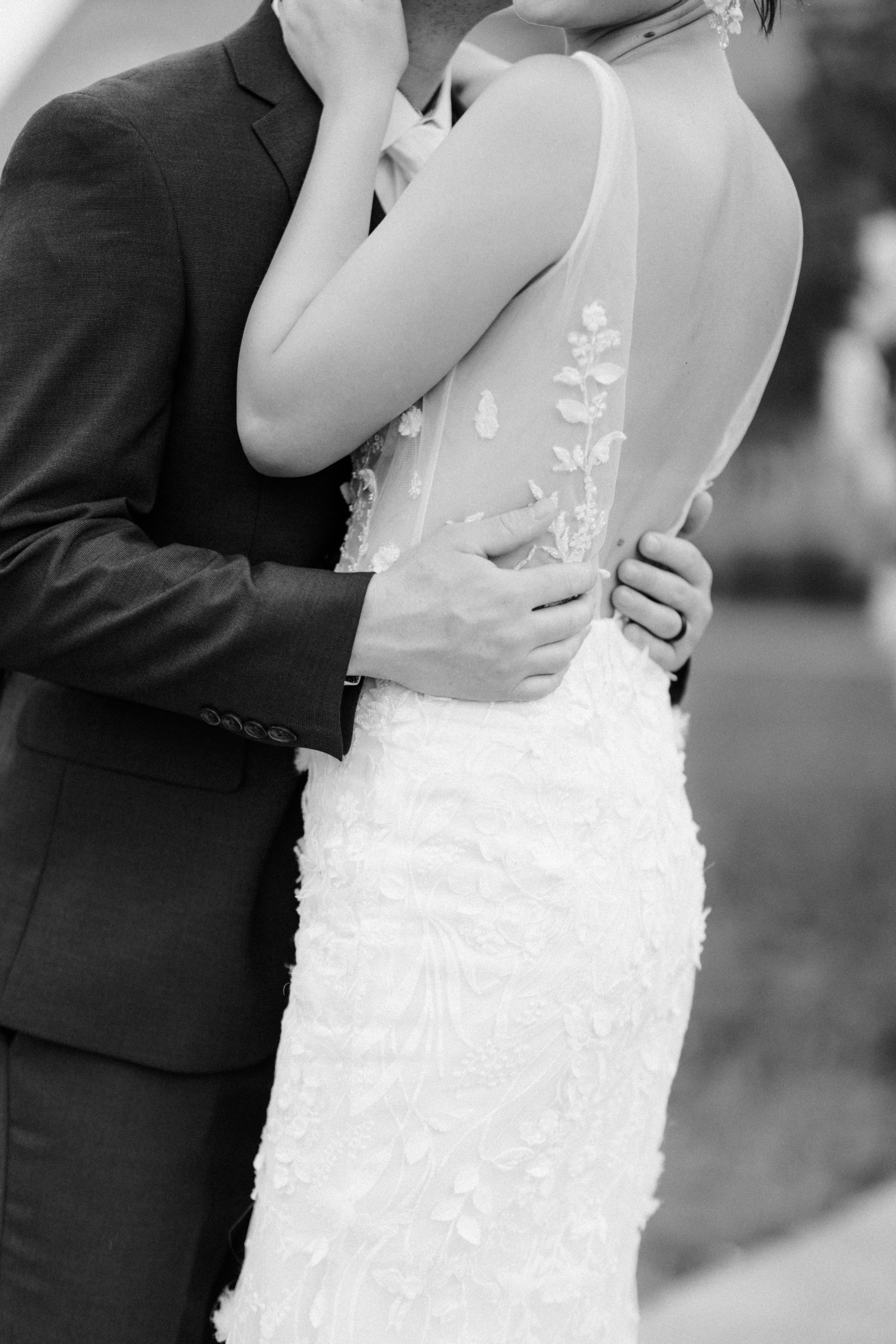 Black and white close up photo of groom embracing bride at their wedding shoot at The Olana
