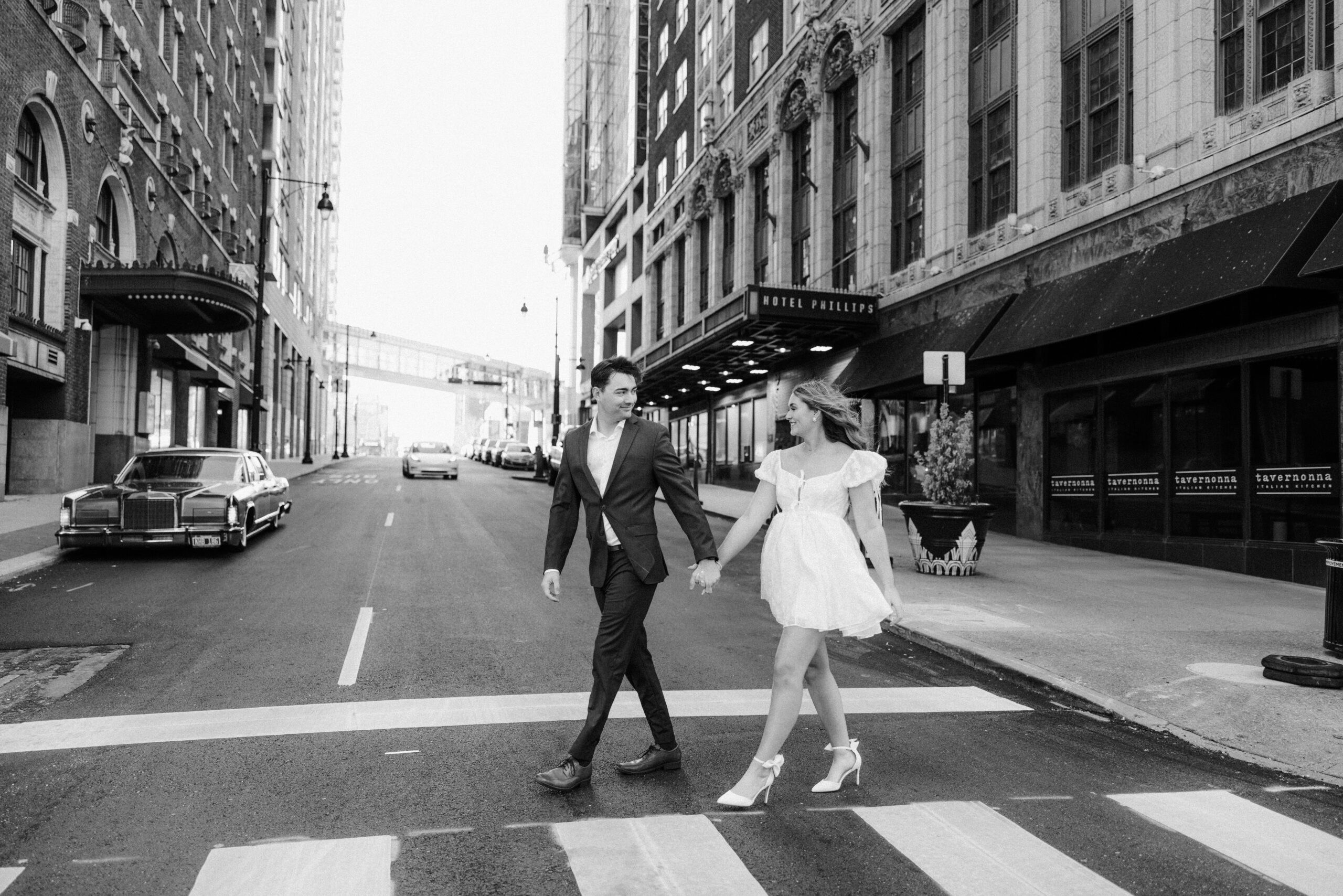 Black and white engagement couple walking down the street in Kansas city, Missouri. Tatyana Zadorin Photography
