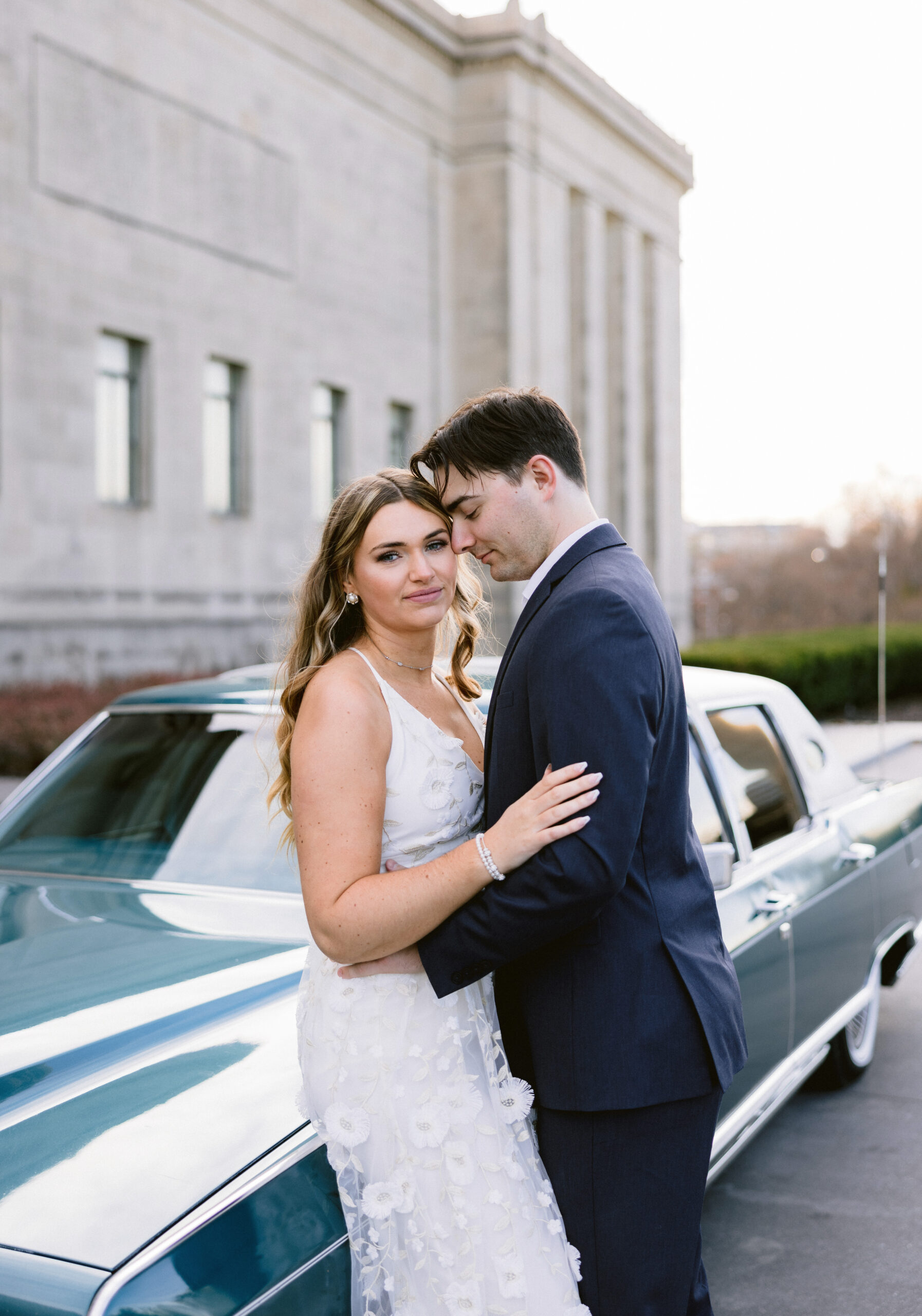wedding couple in Kansas City, Missouri leaning into each other next to a vintage car by Tatyana Zadorin Photography closeup photoshoot