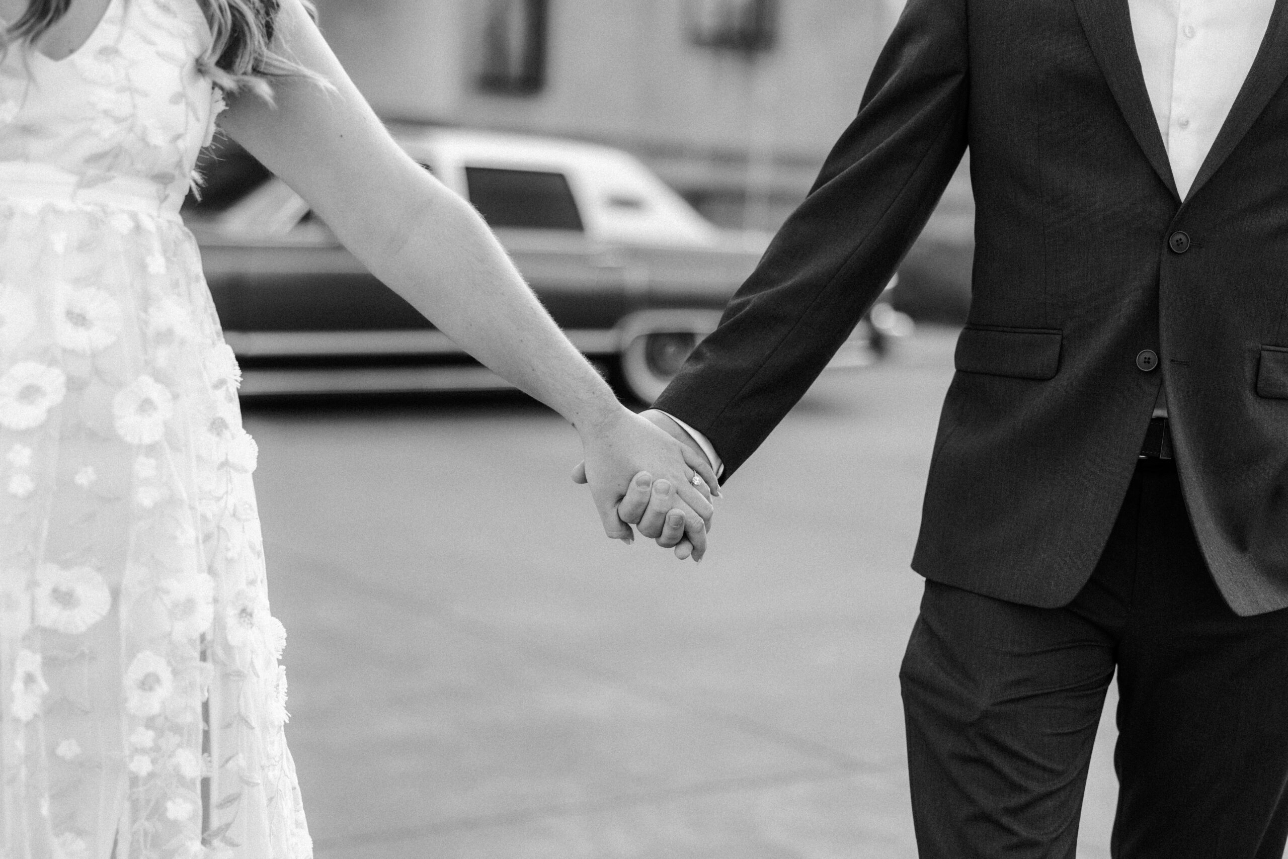 Fine art Photography. Couple holding hands closeup in black and white photos