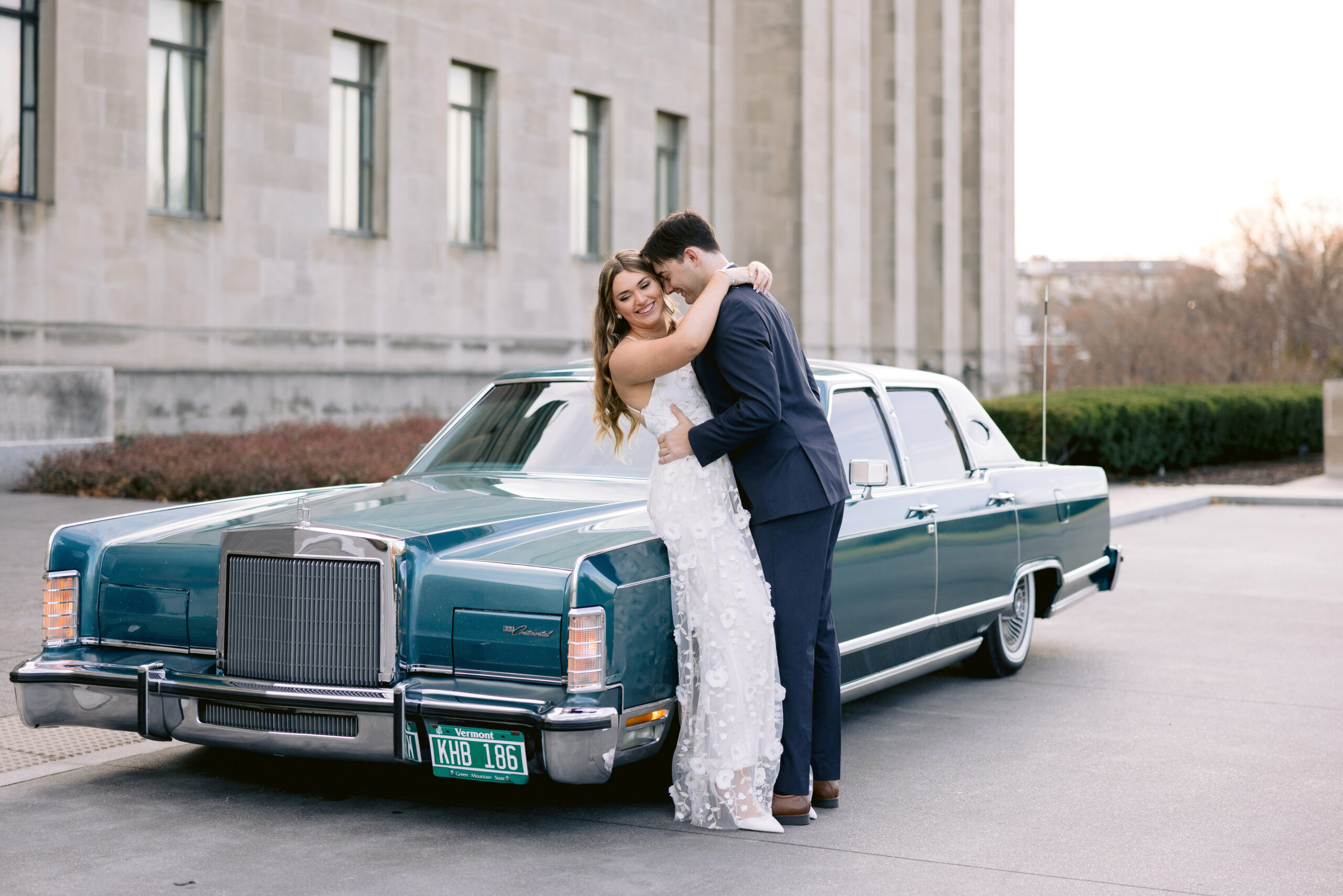 engagement couple in Kansas City, Missouri leaning into each other next to a vintage car by Tatyana Zadorin Photography