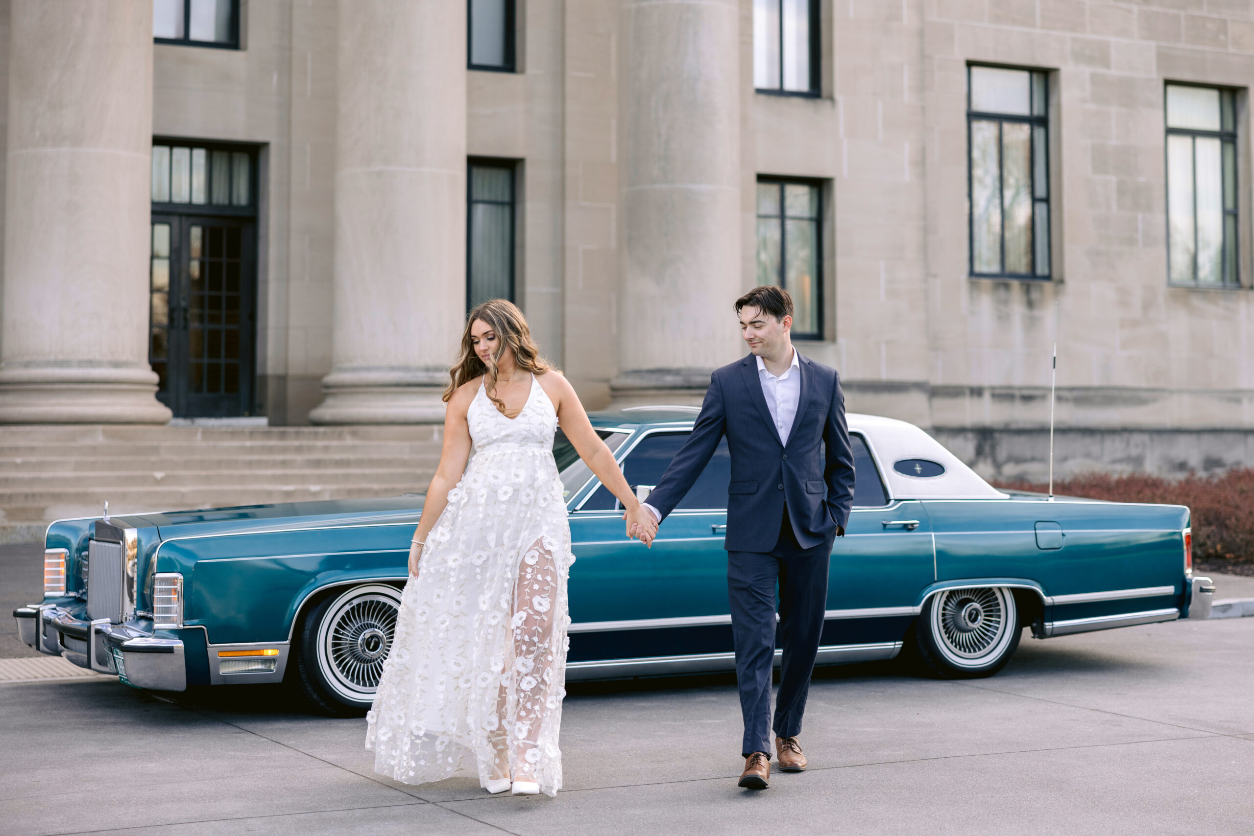 Engagement session by a vintage car. couple walking besides each other in Kansas city, couples photoshoot by Tatyana zadorin Photography