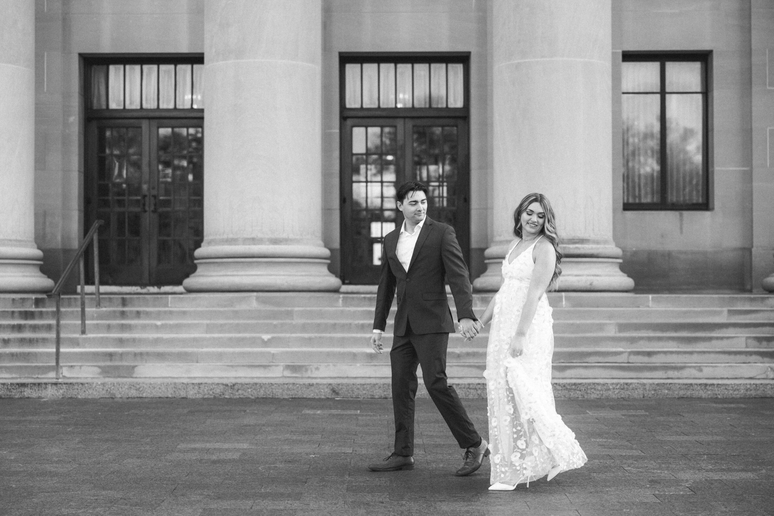 black and white portrait of an engagement couple walking beside each other