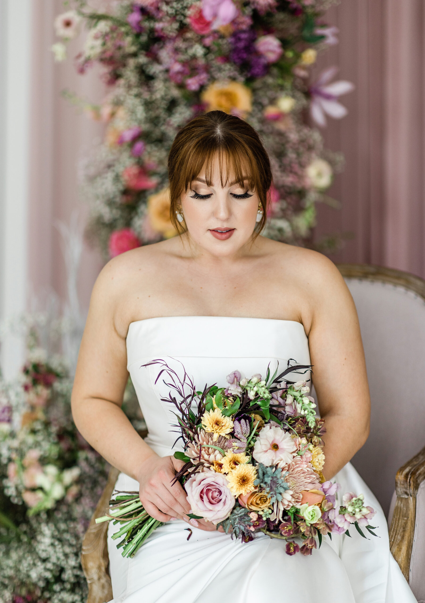 Closeup of bride looking down at her bouquet details by Tatyana Zadorin Photography in Branson, Missouri
