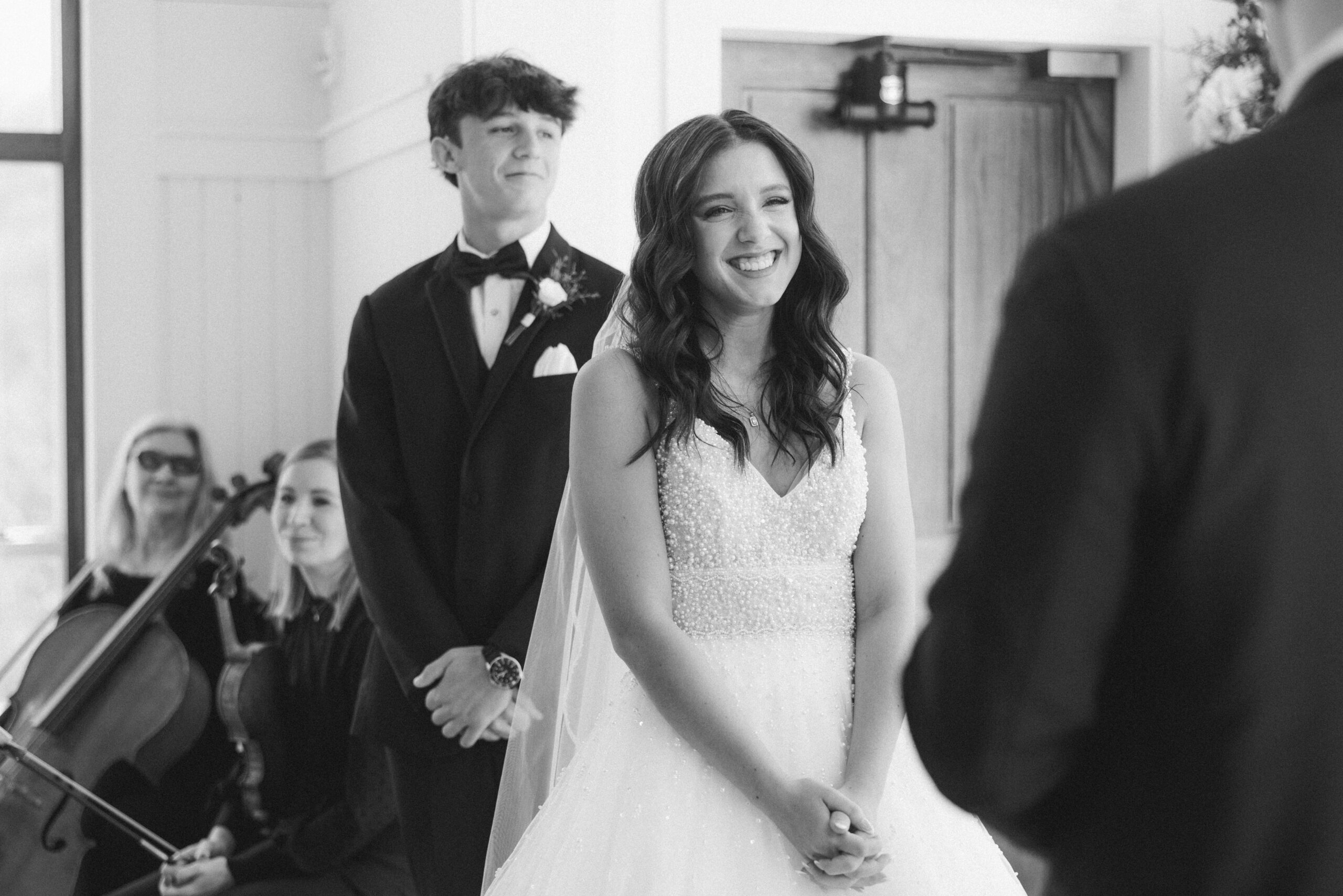 bride smiling when groom is reading his vows. Tatyana Zadorin Photography