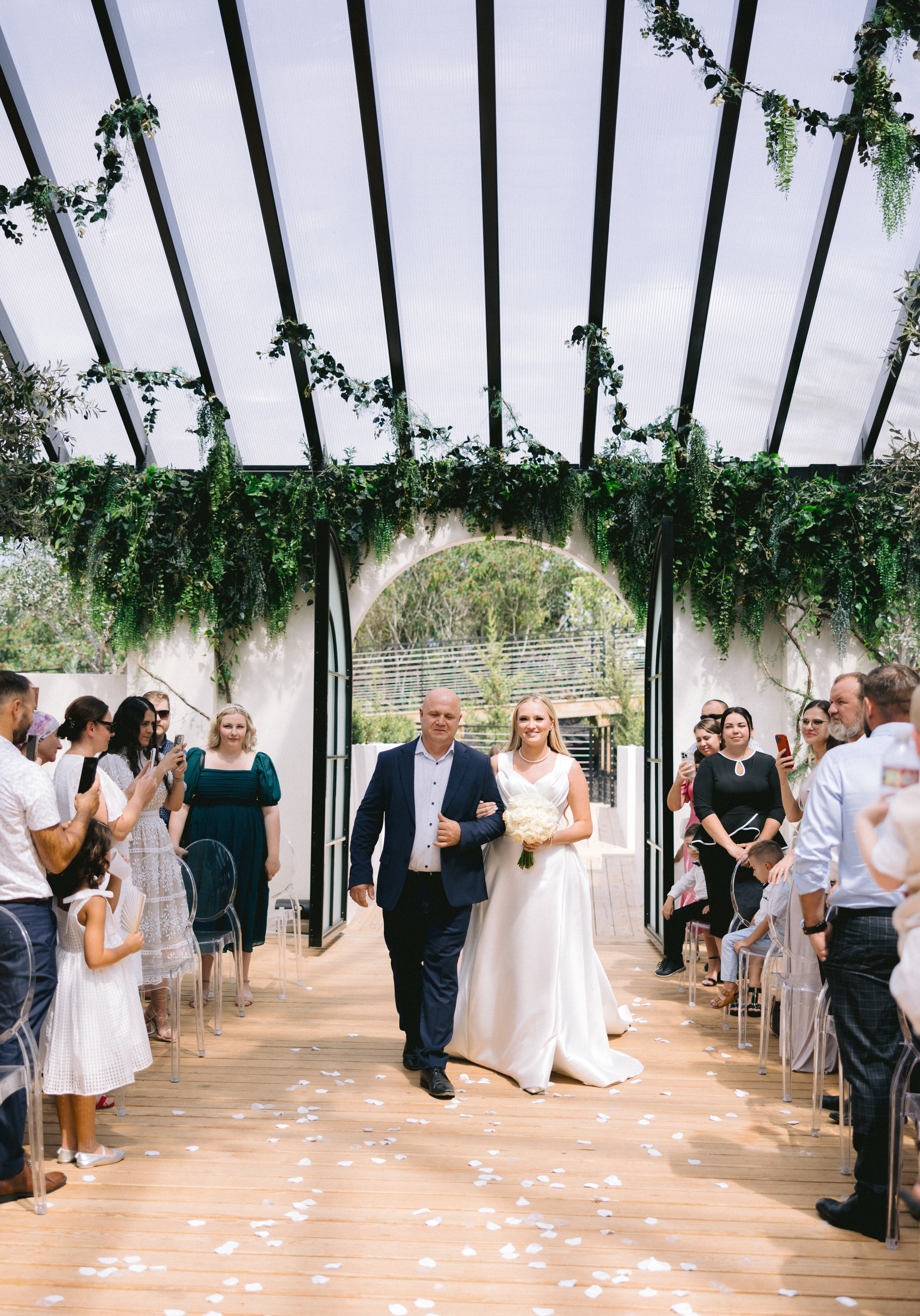 Father of bride walking bride down the isle at Greenhouse Two rivers shot by Tatyana Zadorin Photography