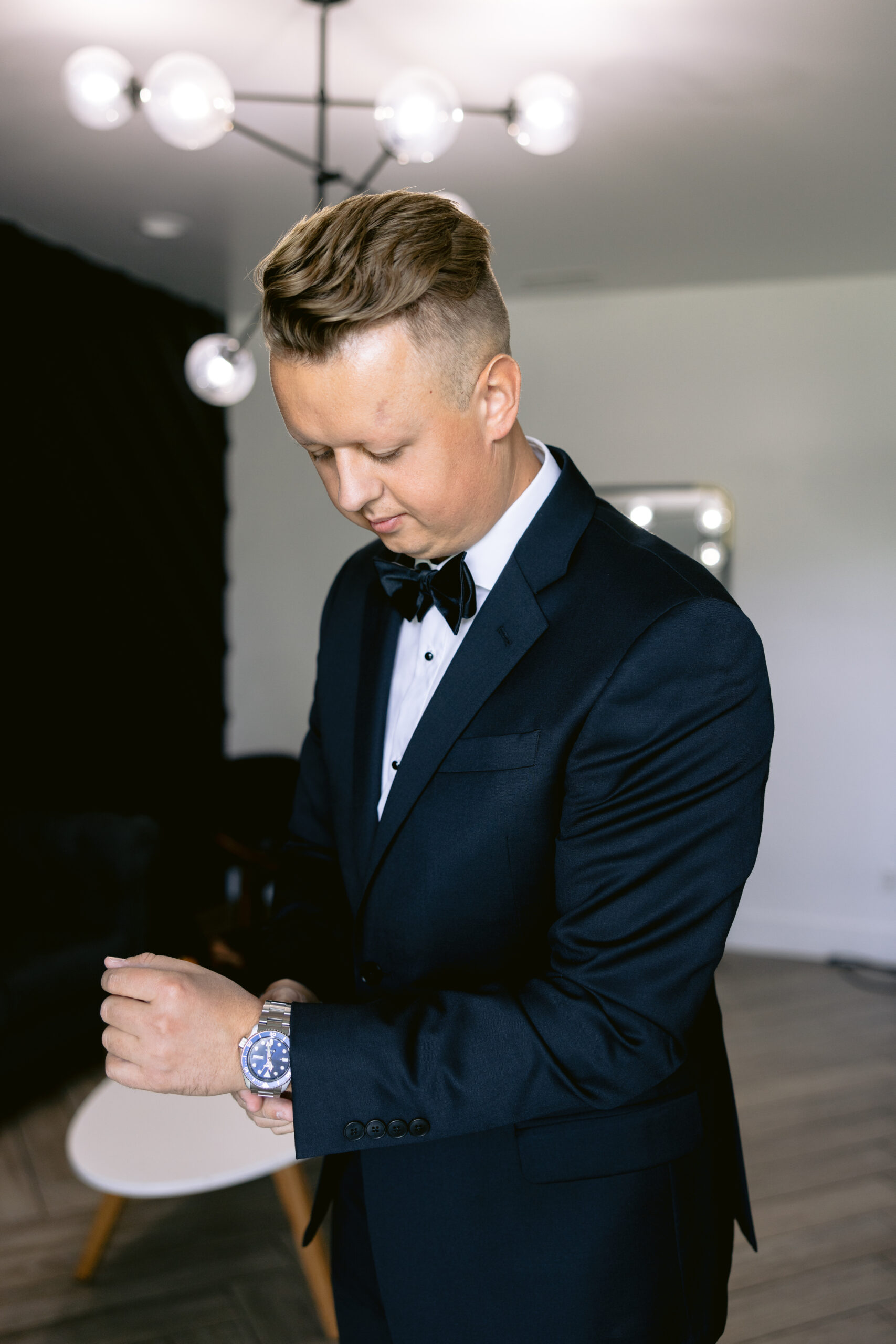 Groom getting ready and adjusting his watch photographed by Tatyana Zadorin Photography