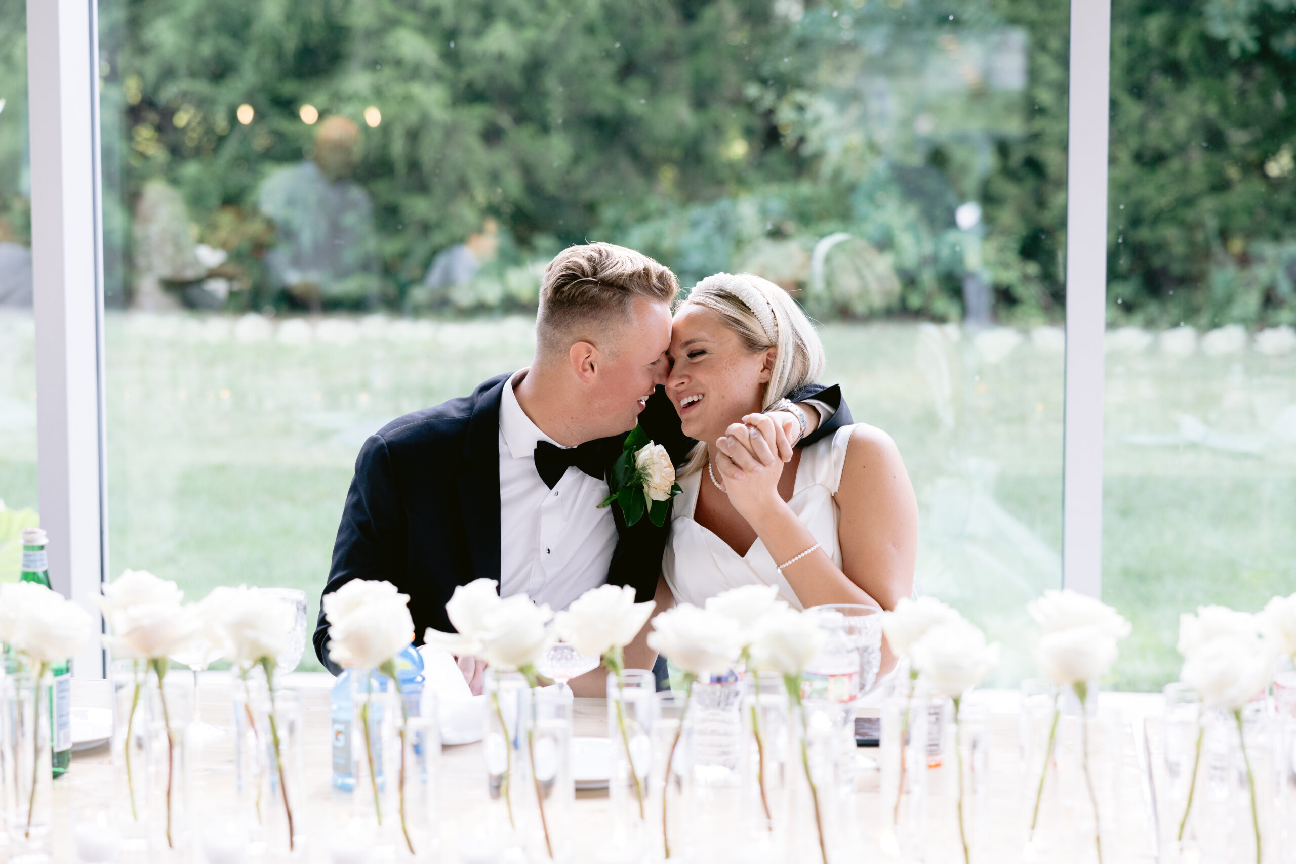 bride and groom at the reception table looking at each other at the Greenhouse Two rivers wedding shot by Tatyana Zadorin Photography