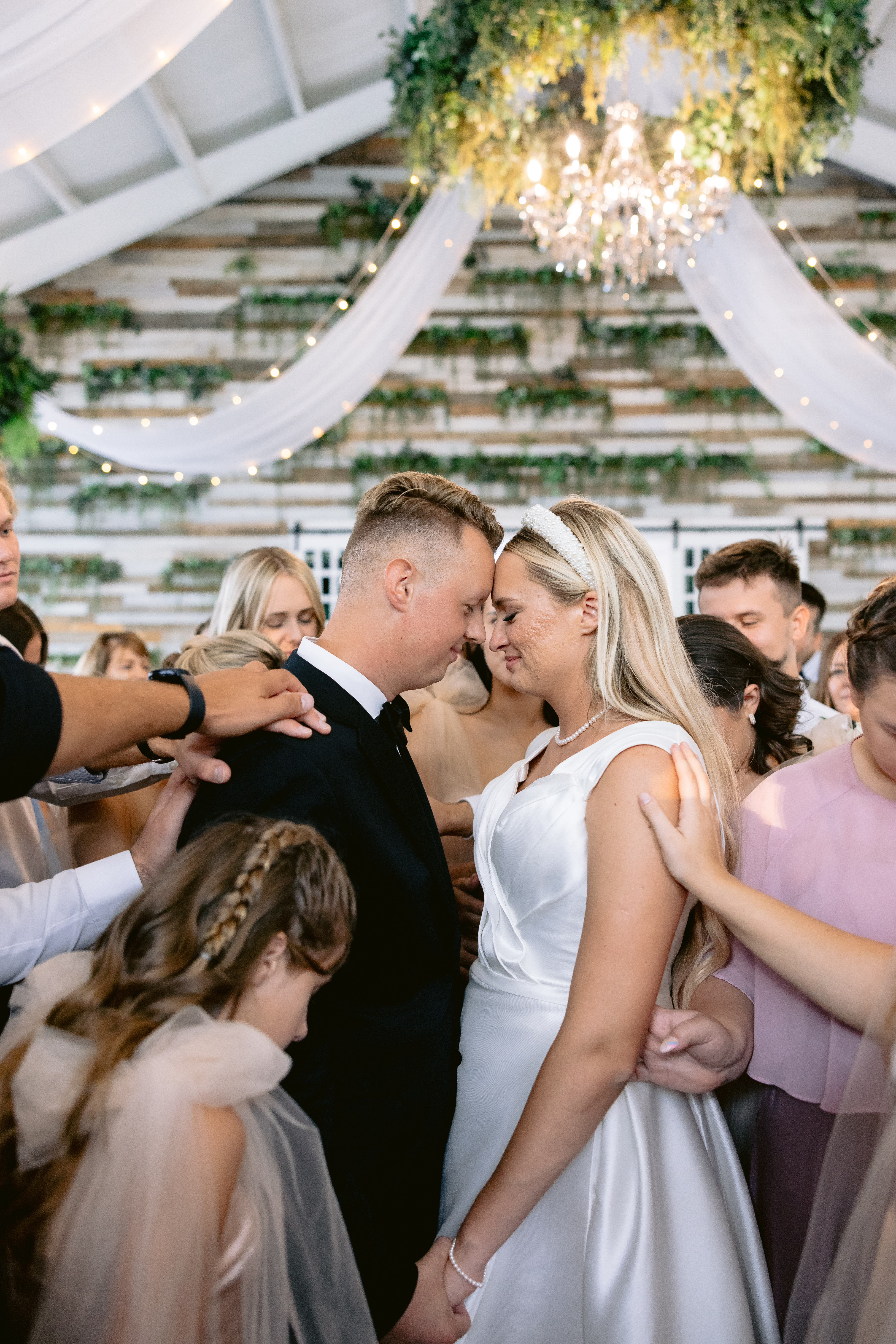 Bride and groom getting prayed over at the Greenhouse Two Rivers photographed by Tatyana Zadorin Photography