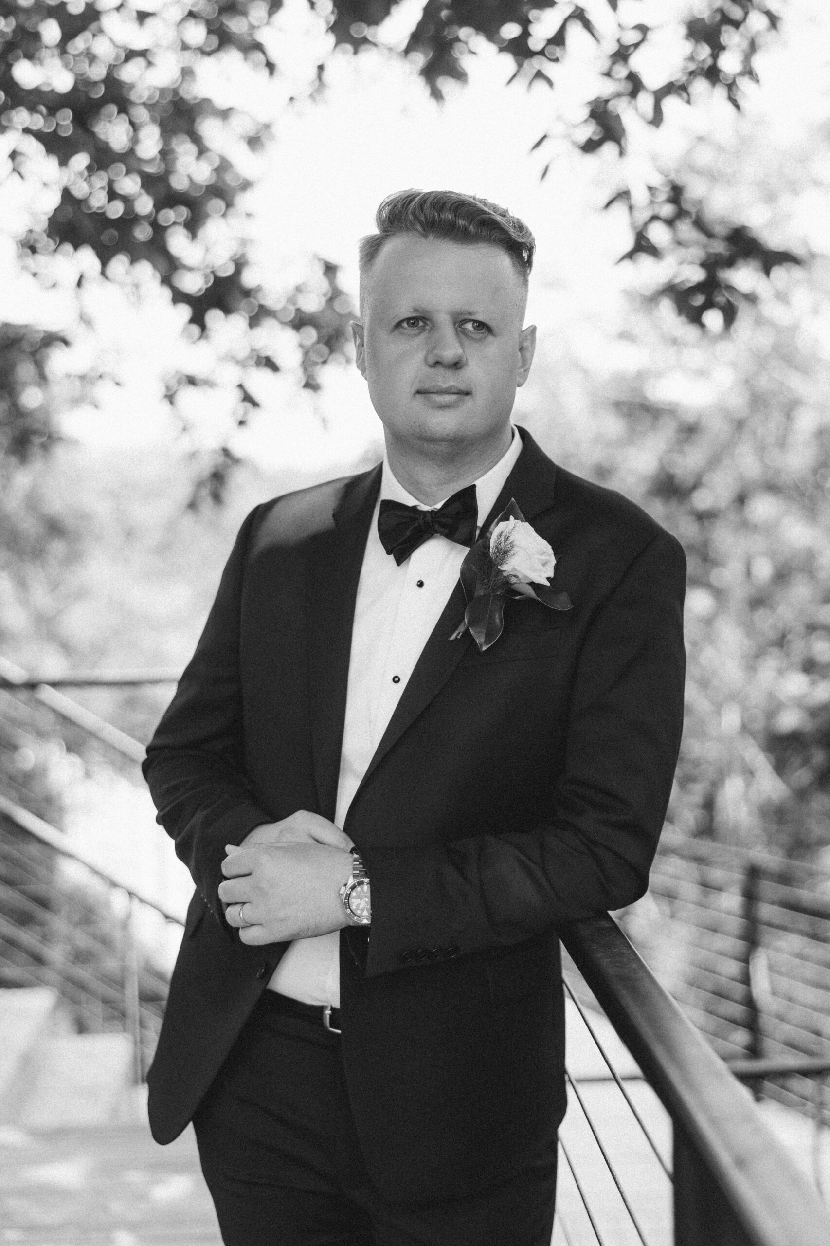 Black and white portrait of groom shot by Tatyana Zadorin Photography. Springfield wedding photography. Greenhouse Two rivers wedding. Groom looking out into the distance