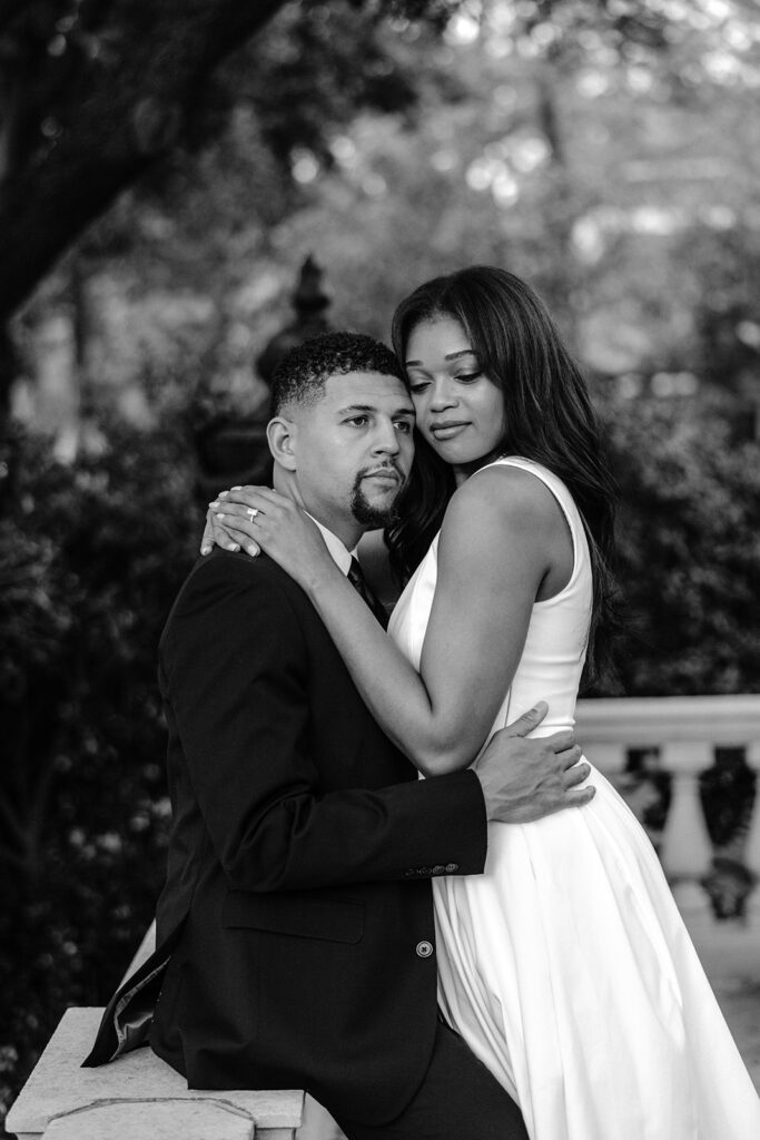 Timeless black-and-white engagement portrait of a couple sharing an intimate embrace during their Aldredge House engagement session.