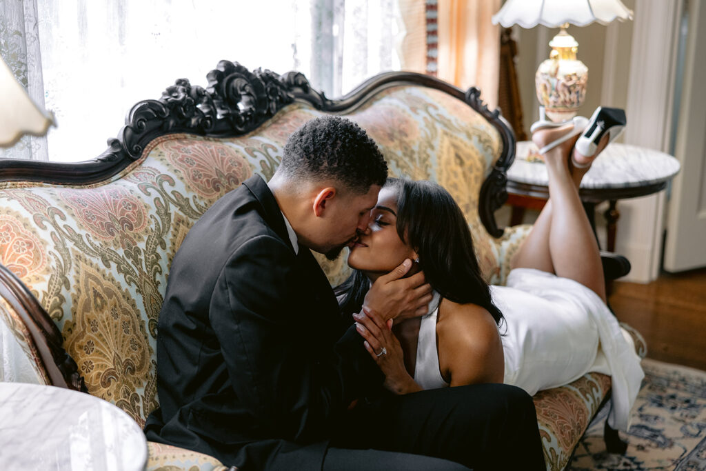 Romantic close-up engagement portrait of a couple kissing during an elegant indoor engagement session at the Aldredge House in Dallas, Texas.