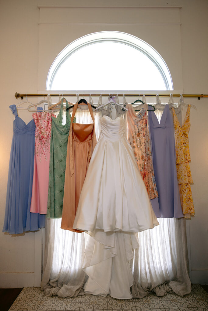 Elegant bridal details and getting-ready moments featuring the bride's wedding dress, bridesmaids in colorful robes, bridal party portraits, emotional candid moments, and timeless bridal preparations at The French Farmhouse wedding venue in Collinsville, Texas.