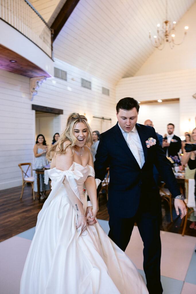 Lively wedding reception featuring the bride and groom's grand entrance, joyful dancing, fun reception games, candid guest reactions, and celebration moments at The French Farmhouse wedding venue in Collinsville, Texas.